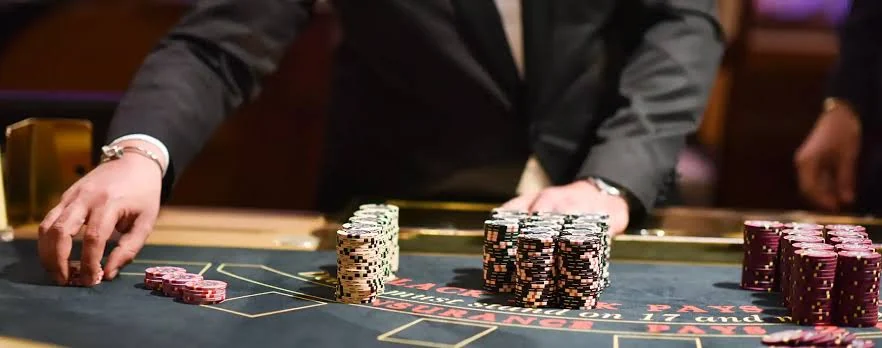 Professional event hosts preparing an elegant casino-style table before guests arrive