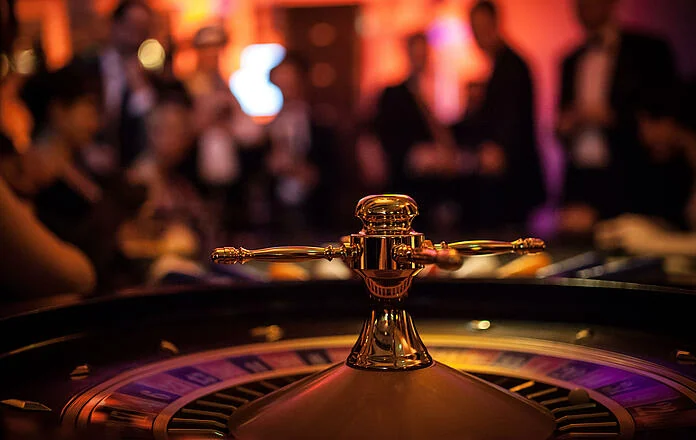 An elegant roulette-style entertainment table in a softly lit venue